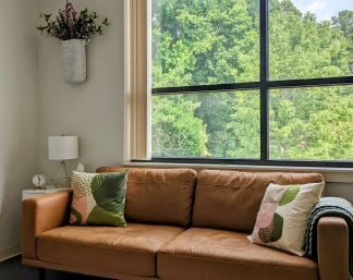 A couch, window and office decor make the office a warm and inviting place to come. We welcome those wanting a Christian counselor to guide them through healing and renewal. Christian counseling in Raleigh NC can be a part of your story to begin healing today. Find healing and renewal through Christian counseling!