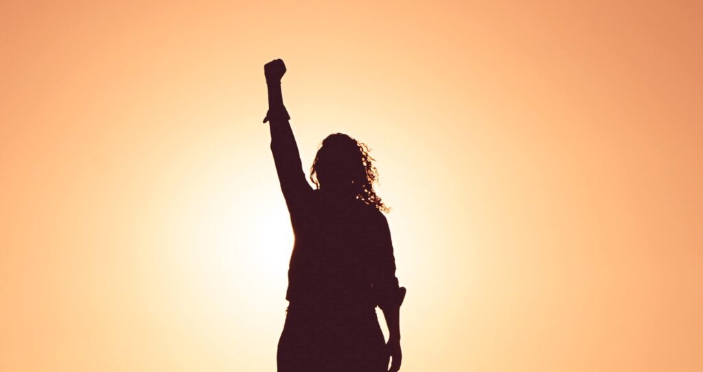 woman with fist raised from christian counseling